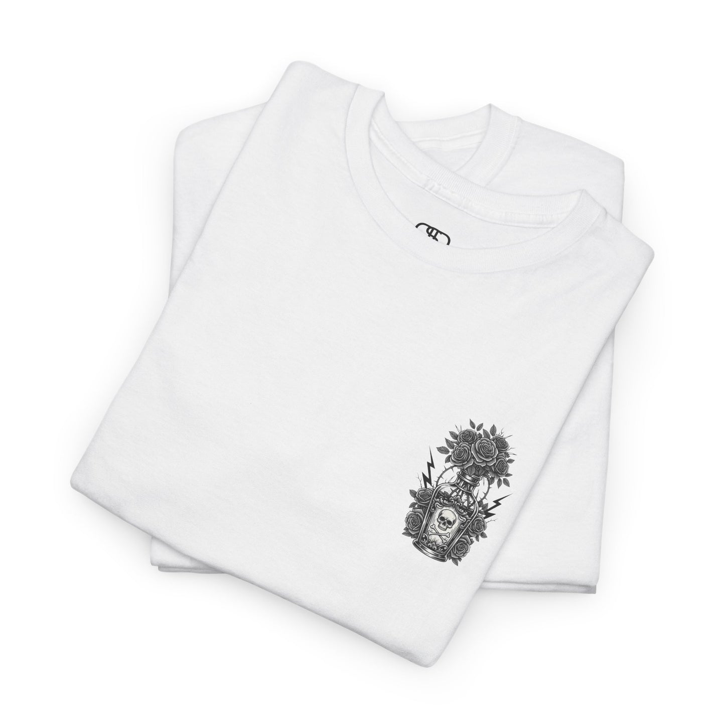 A folded white t-shirt with a skull and crossbones vase filled with roses and the words “Surviving Purely Out of Spite” in a gothic font.