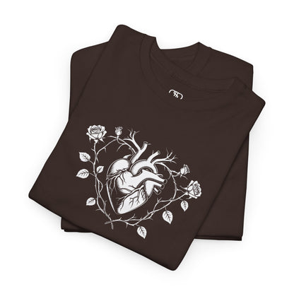 A folded dark brown t-shirt with a heart surrounded by thorn vines, red roses, and green leaves graphic.