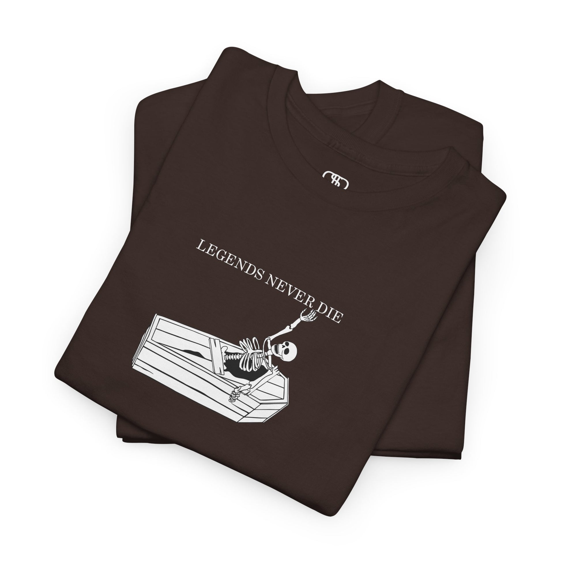 A folded dark brown T-shirt with a skeleton breaking free from a casket, reaching up towards "Legends Never Die" text.