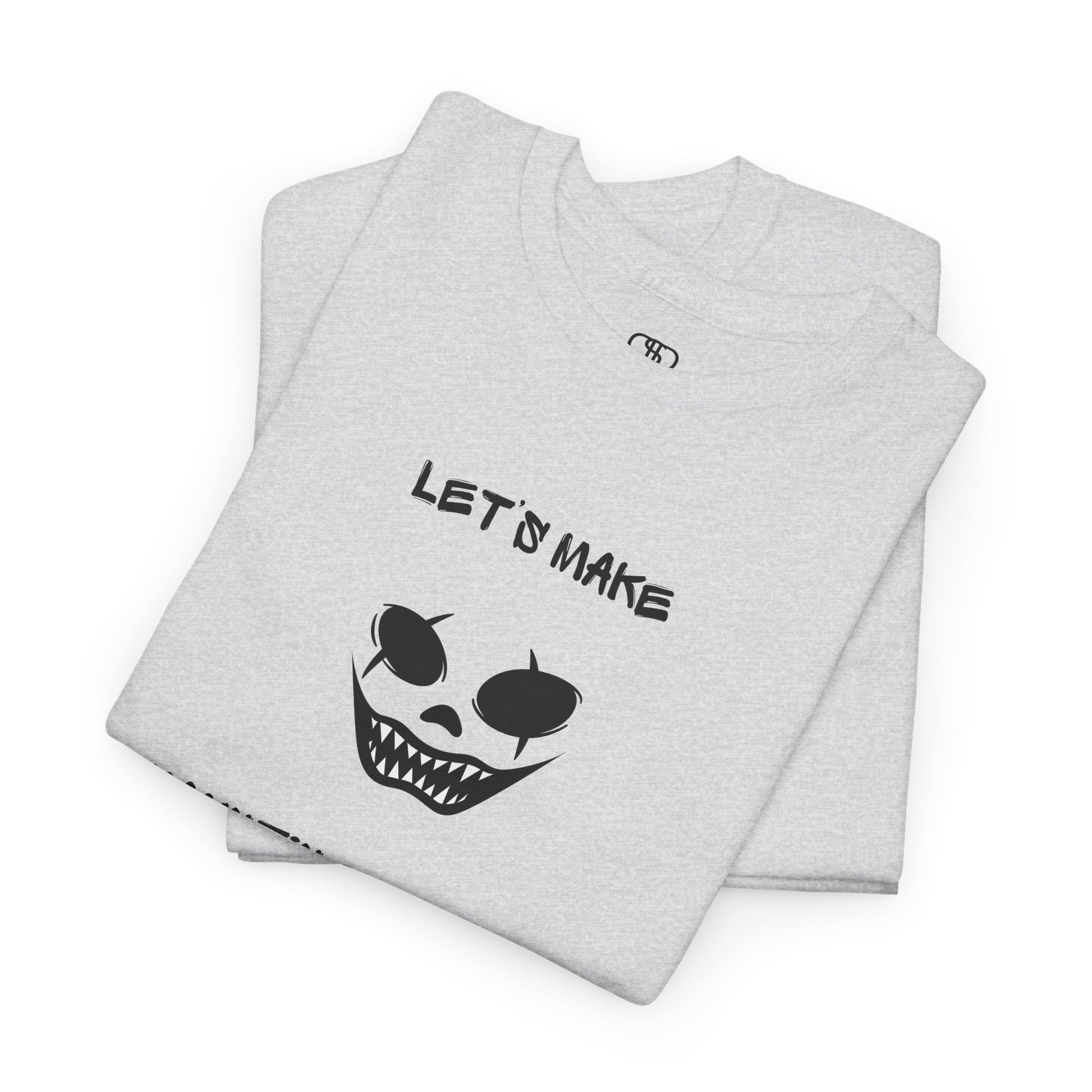A Folded ash gray T-shirt with a daring clown graphic with sharp teeth and scars, and "Let’s Make Haunting Memories" text.