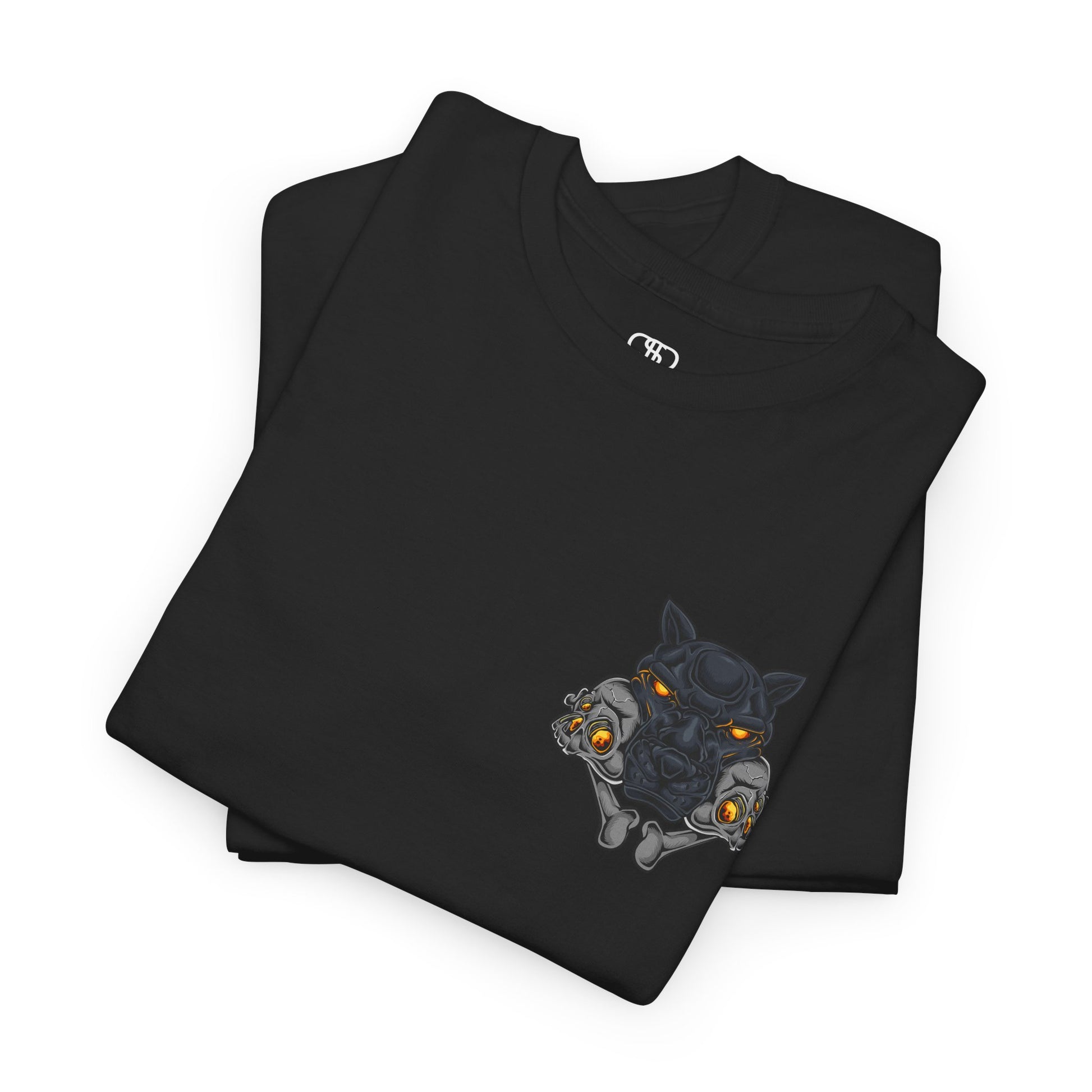 A folded black T-shirt with a daring dog graphic biting two skulls, all with glowing molten lava-like eyes.