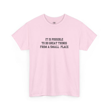 A light pink t-shirt with the quote “It is possible to do great things from a small place” on the front.