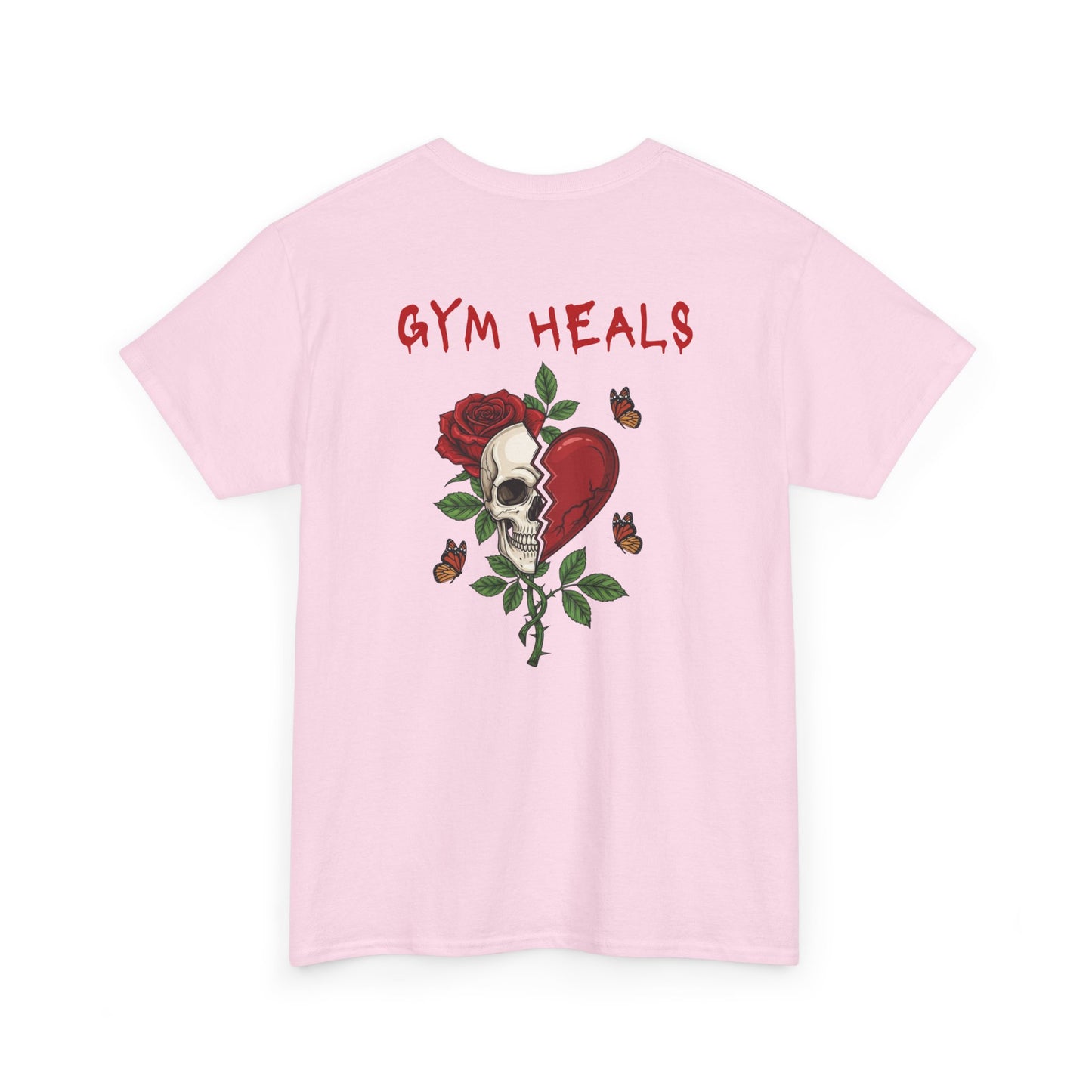 A light pink t-shirt with a front design of a half skull, half broken heart, and a rose. The back reads "Gym Heals" in red.