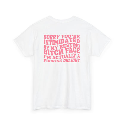 A white t-shirt with a skeletal hand in a bubble on the front and the phrase “Sorry you’re intimidated by my resting Bitch ace I’m actually a fucking delight” on the back.