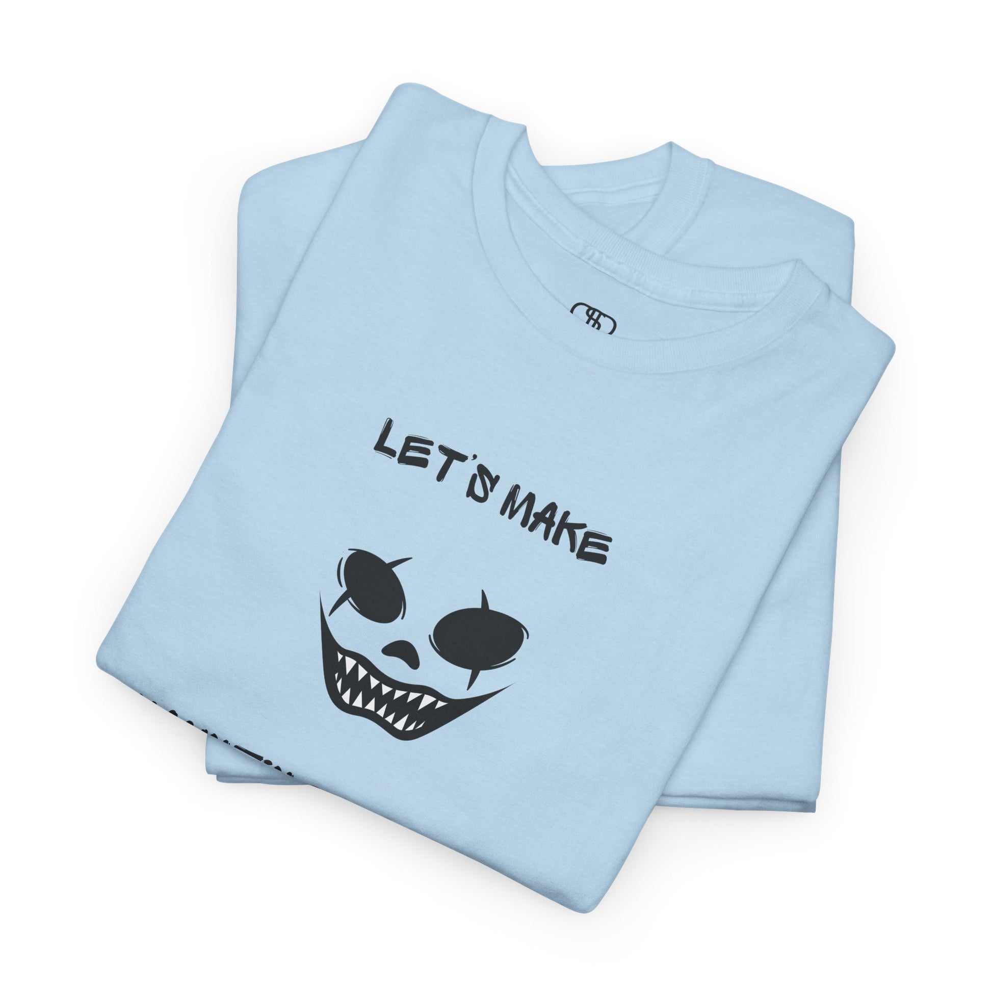 A folded light blue T-shirt with a daring clown graphic with sharp teeth and scars, and "Let’s Make Haunting Memories" text.