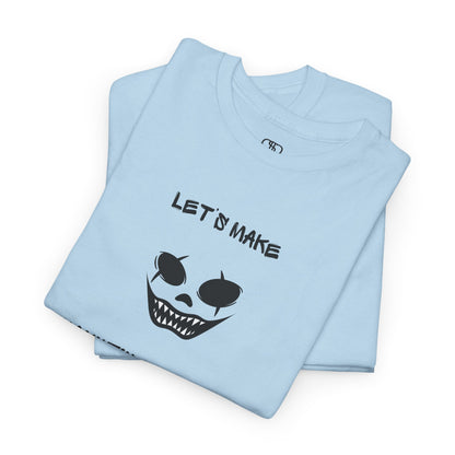 A folded light blue T-shirt with a daring clown graphic with sharp teeth and scars, and "Let’s Make Haunting Memories" text.
