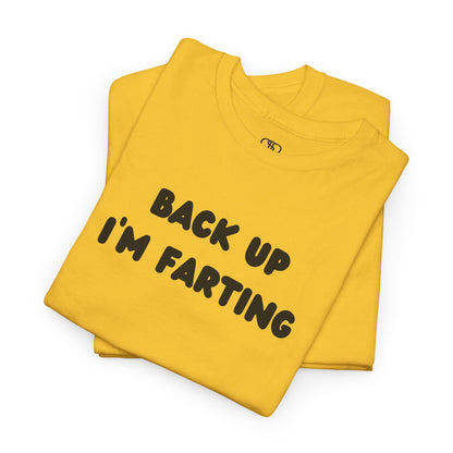 A folded daisy yellow T-shirt with the bold text "Back Up I'm Farting" on the front.