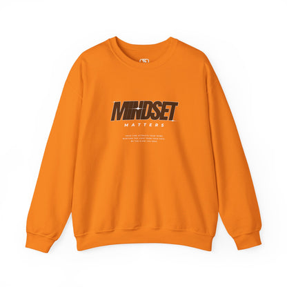 An orange sweater "Mindset Matters" text with stars on a sweater, inspirational quote below the main quote. 