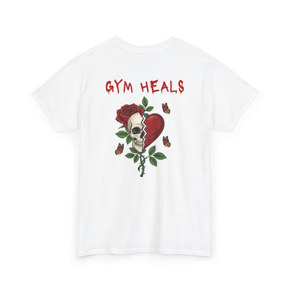A white t-shirt with a front design of a half skull, half broken heart, and a rose. The back reads "Gym Heals" in red.