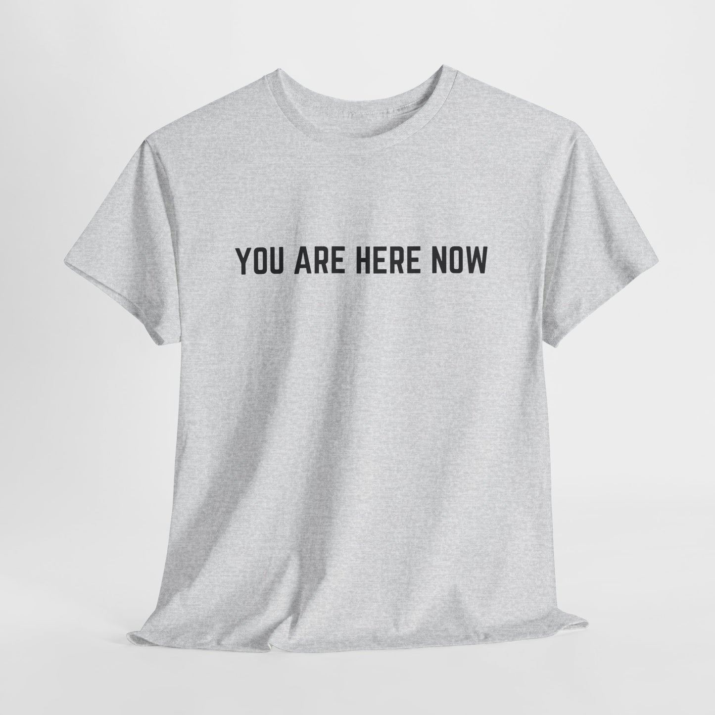 Front of a t-shirt with the grounding phrase "You are Here now" in a clean, minimalist font.