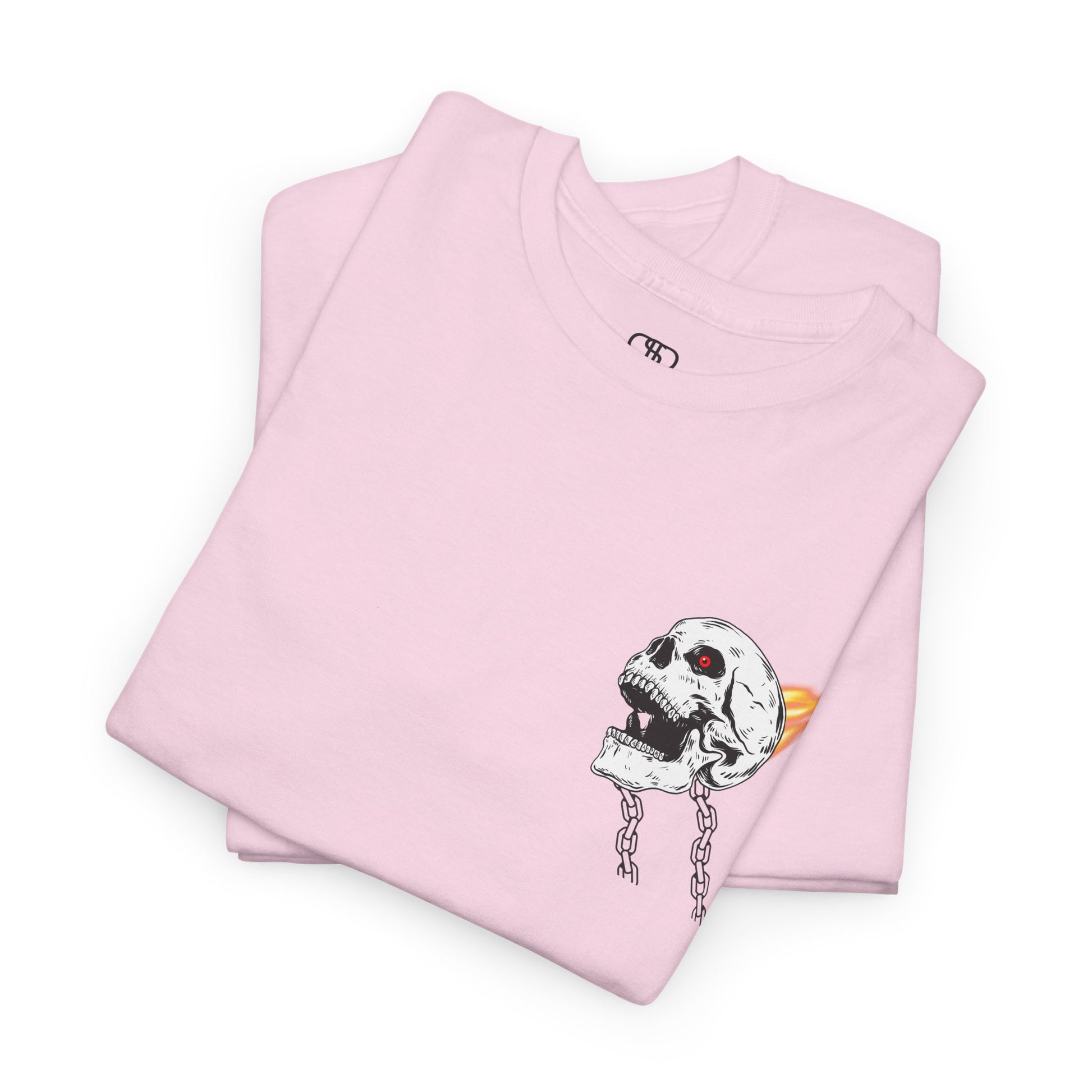 A folded light pink T-shirt with a daring skeleton graphic, red glowing eye, chains forming wings, and a flame background