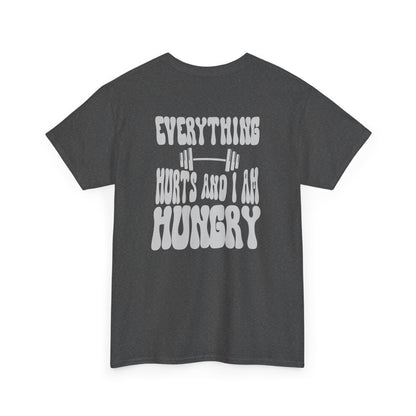 A heather gray t-shirt with a smiley face emoji on the front and the phrase “Everything Hurts and I am Hungry” in a retro font on the back.