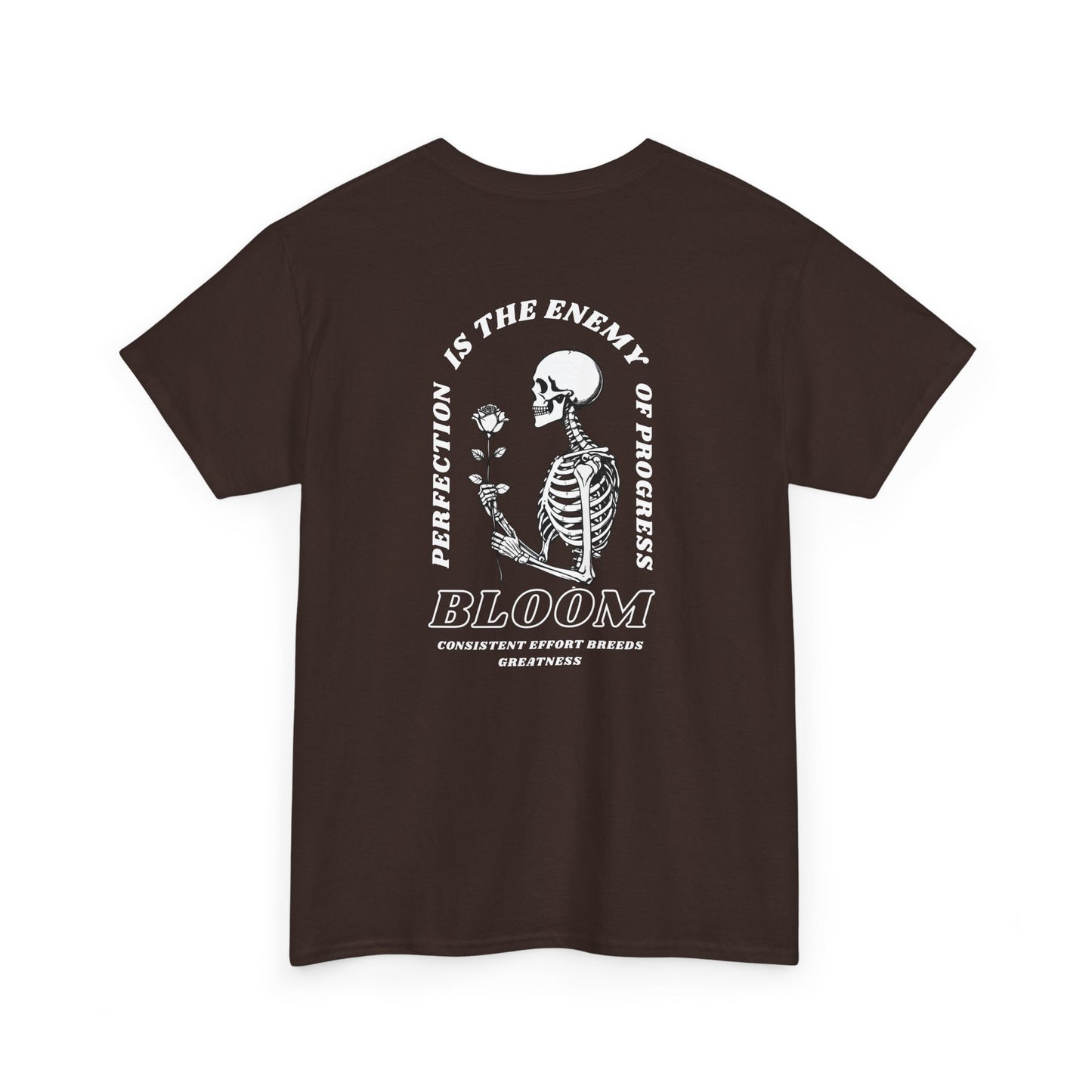 A [dark brown] t-shirt with a central skeleton and rose design and the words “Perfection is the enemy of progress” and “Bloom” on the front.