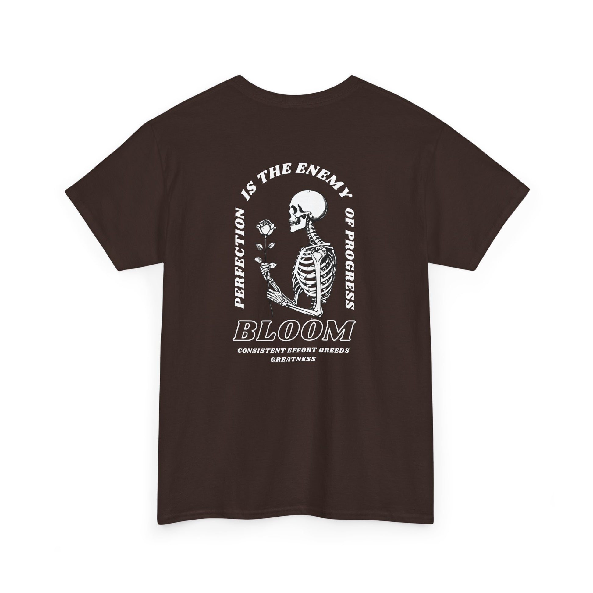 A [dark brown] t-shirt with a central skeleton and rose design and the words “Perfection is the enemy of progress” and “Bloom” on the front.