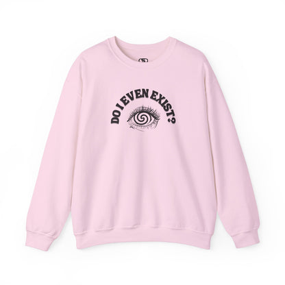 A pink sweatshirt with a graphic print of a detailed, realistic eye that contains an optical illusion of a spiral. The text "Do I even Exist?" is printed above the eye in a clean font.