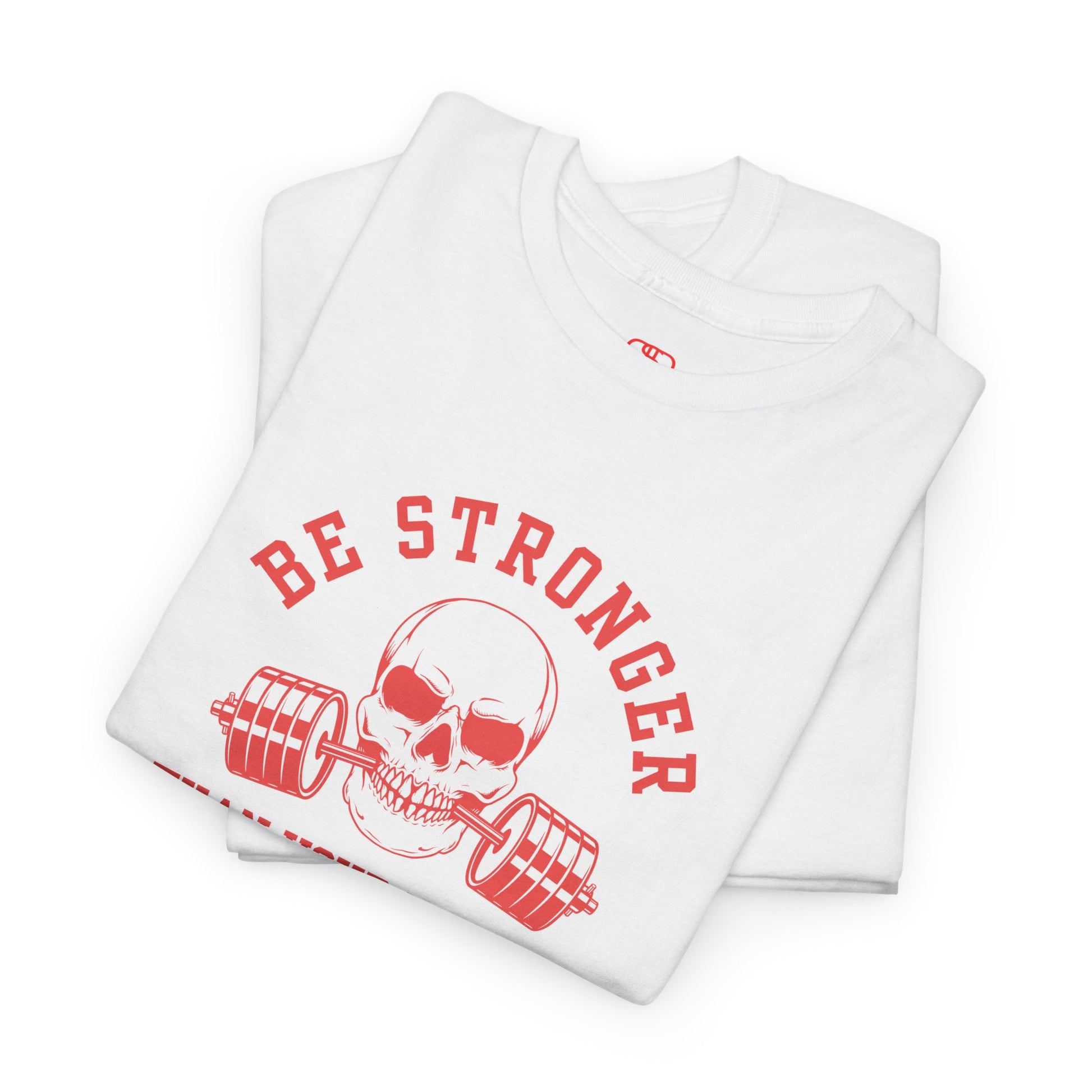 A t-shirt in [folded white] with a skull biting a barbell and the words “Be Stronger Than Your Excuses.”