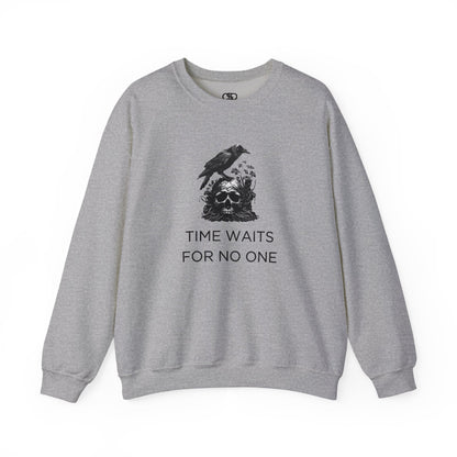 A sweatshirt featuring a detailed illustration of a crow perched on a human skull that is intertwined with overgrown vines and moss. Along with the words Time Waits For No One. 