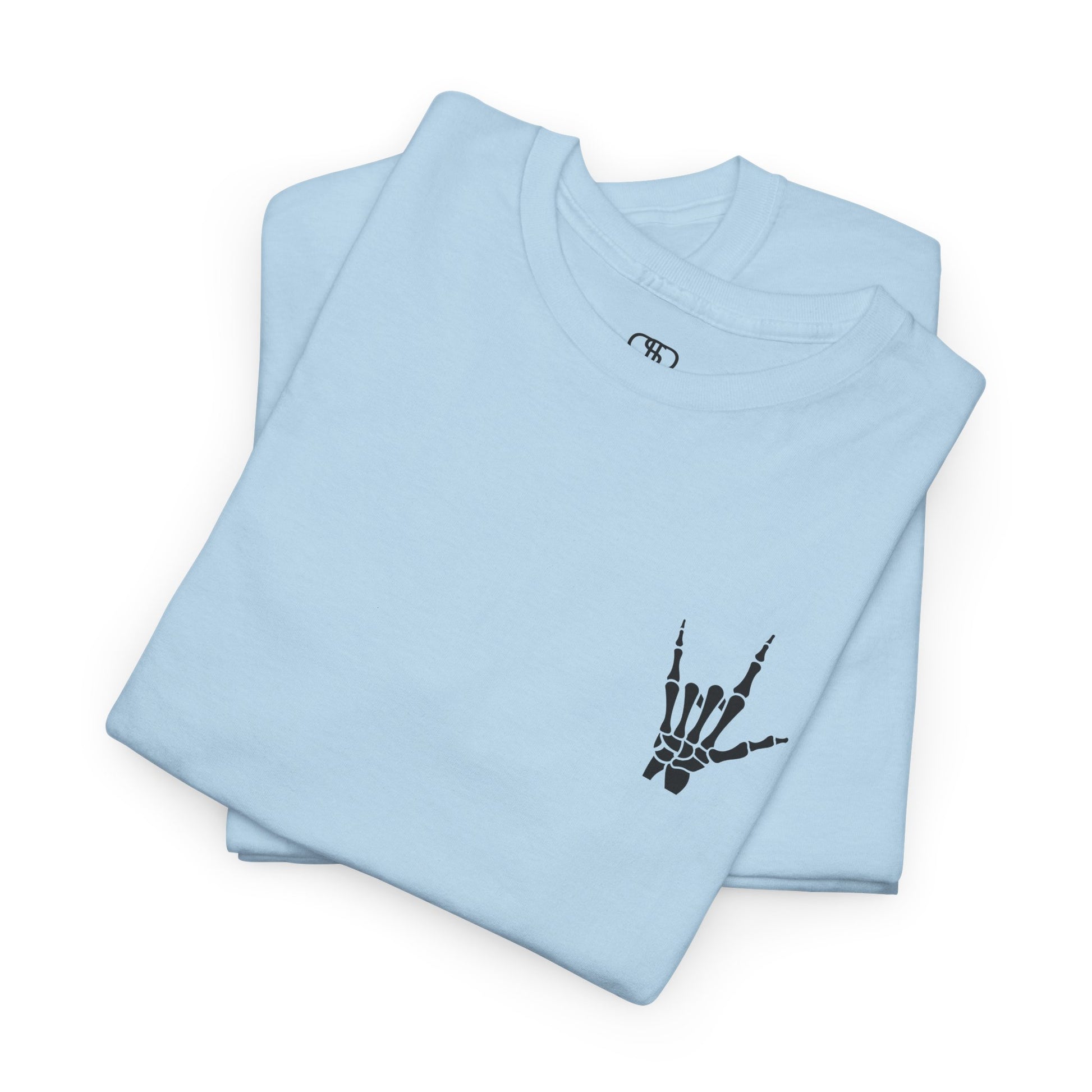 A folded light blue t-shirt with small rock hand symbol on front, and "Rules.. Never Heard of Them" graffiti text on the back.