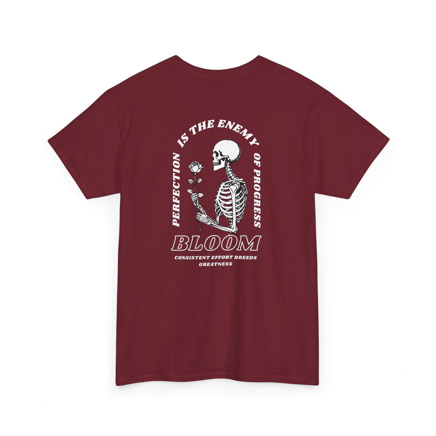 A [red] t-shirt with a central skeleton and rose design and the words “Perfection is the enemy of progress” and “Bloom” on the front.