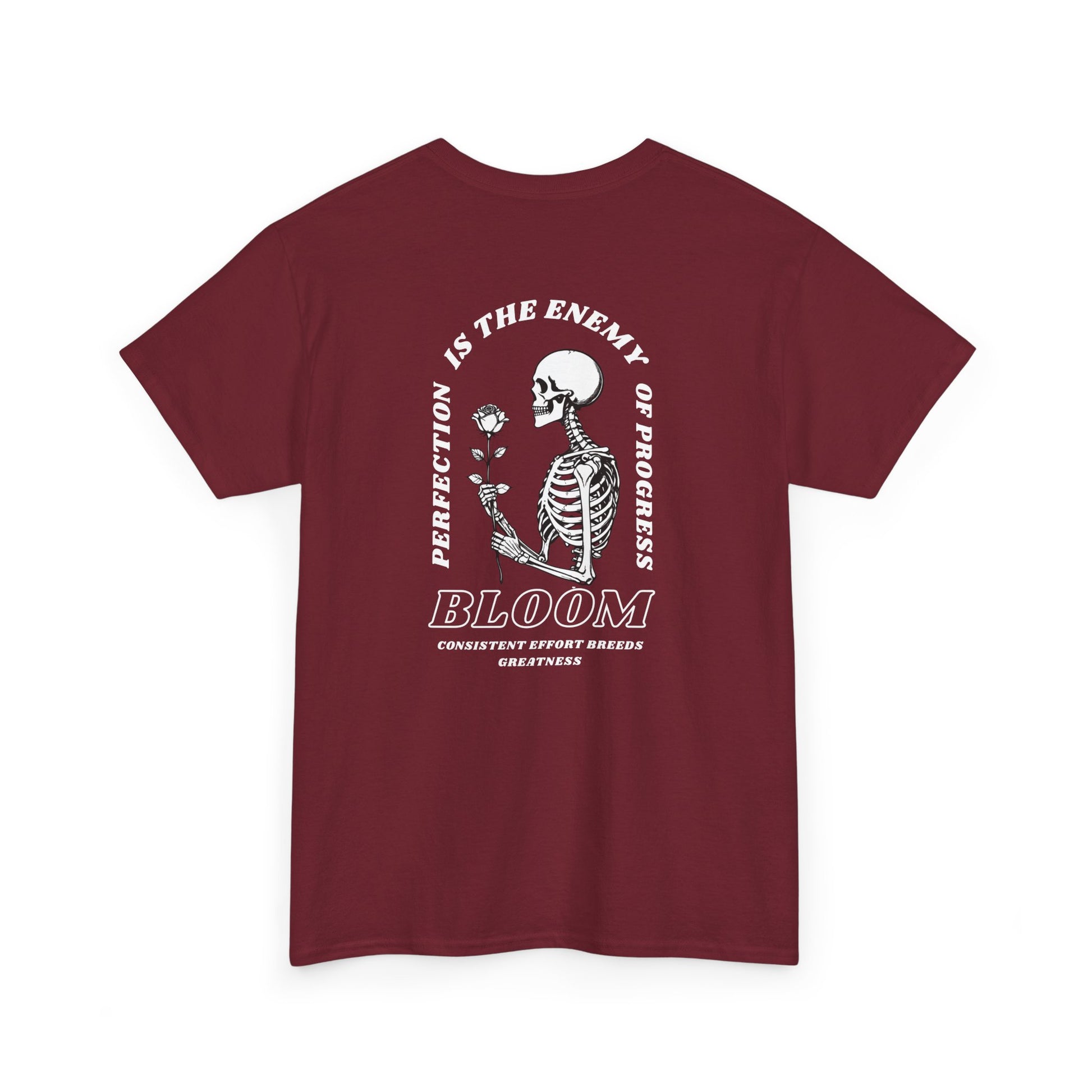 A [red] t-shirt with a central skeleton and rose design and the words “Perfection is the enemy of progress” and “Bloom” on the front.