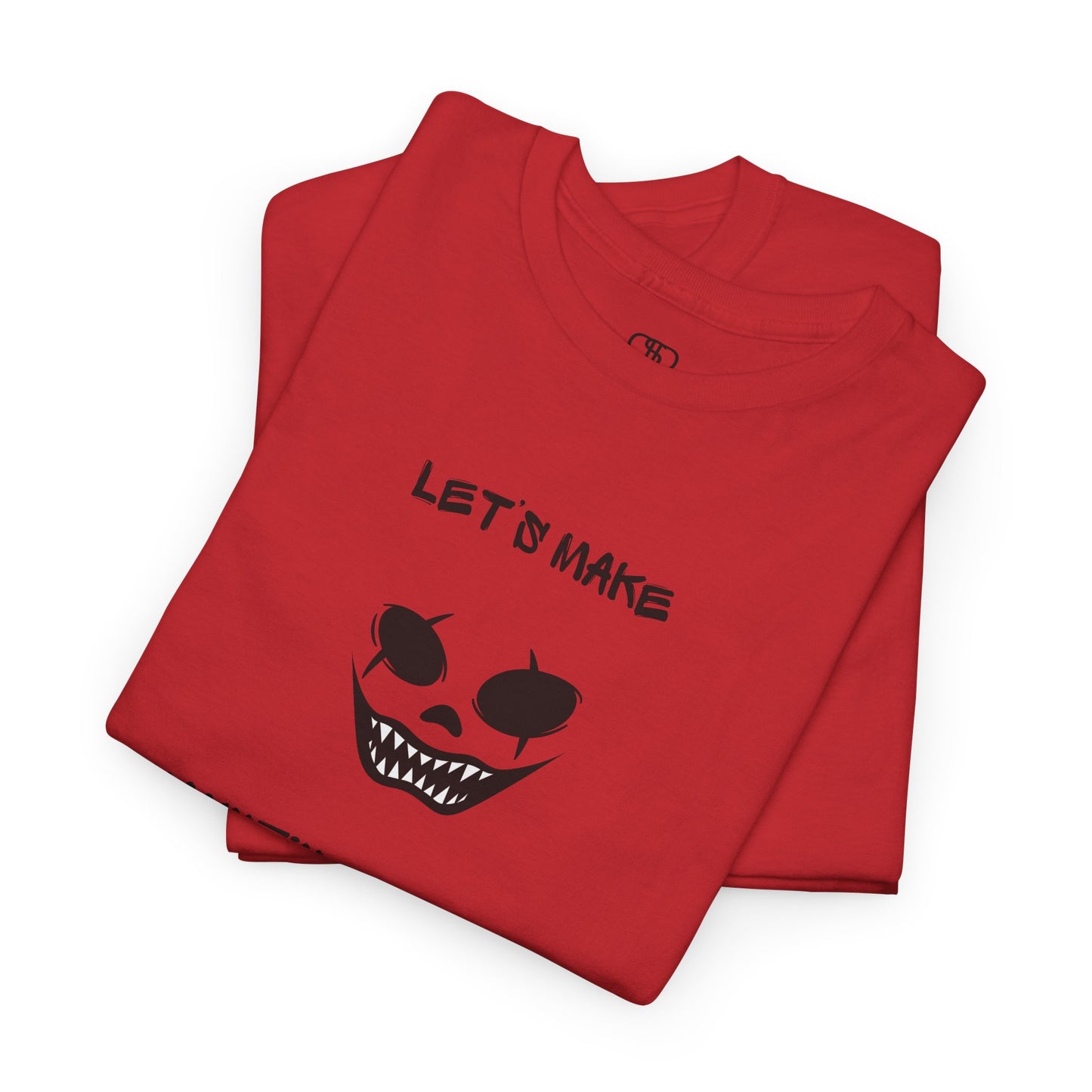 A folded red T-shirt with a daring clown graphic with sharp teeth and scars, and "Let’s Make Haunting Memories" text.