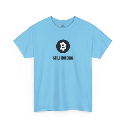 A SKY BLUE T-shirt with a Bitcoin emblem and "Still Holding" text in black.