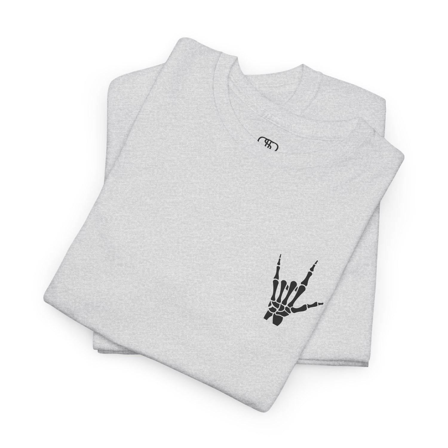 A folded ash gray  t-shirt with small rock hand symbol on front, and "Rules.. Never Heard of Them" graffiti text on the back.