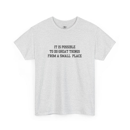 An ash gray t-shirt with the quote “It is possible to do great things from a small place” on the front.