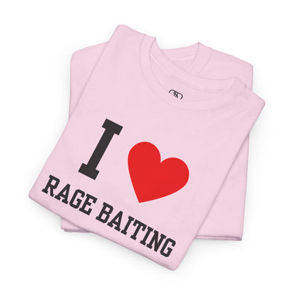 A folded light pink t-shirt featuring the classic "I Love" graphic style with the text "I," a red heart, and the words "Rage Baiting" below it.