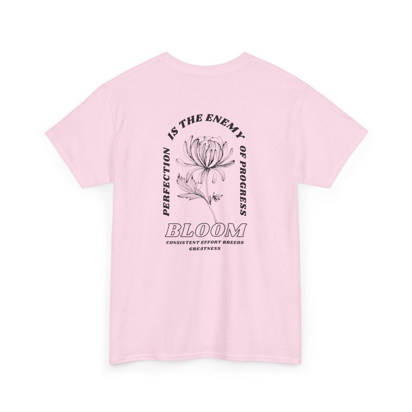 A [light pink] t-shirt with a central flower design and the words “Perfection is the enemy of progress” and “Bloom” underneath it the phrase "Consistent effort breeds greatness," featured on the back of the t-shirt.