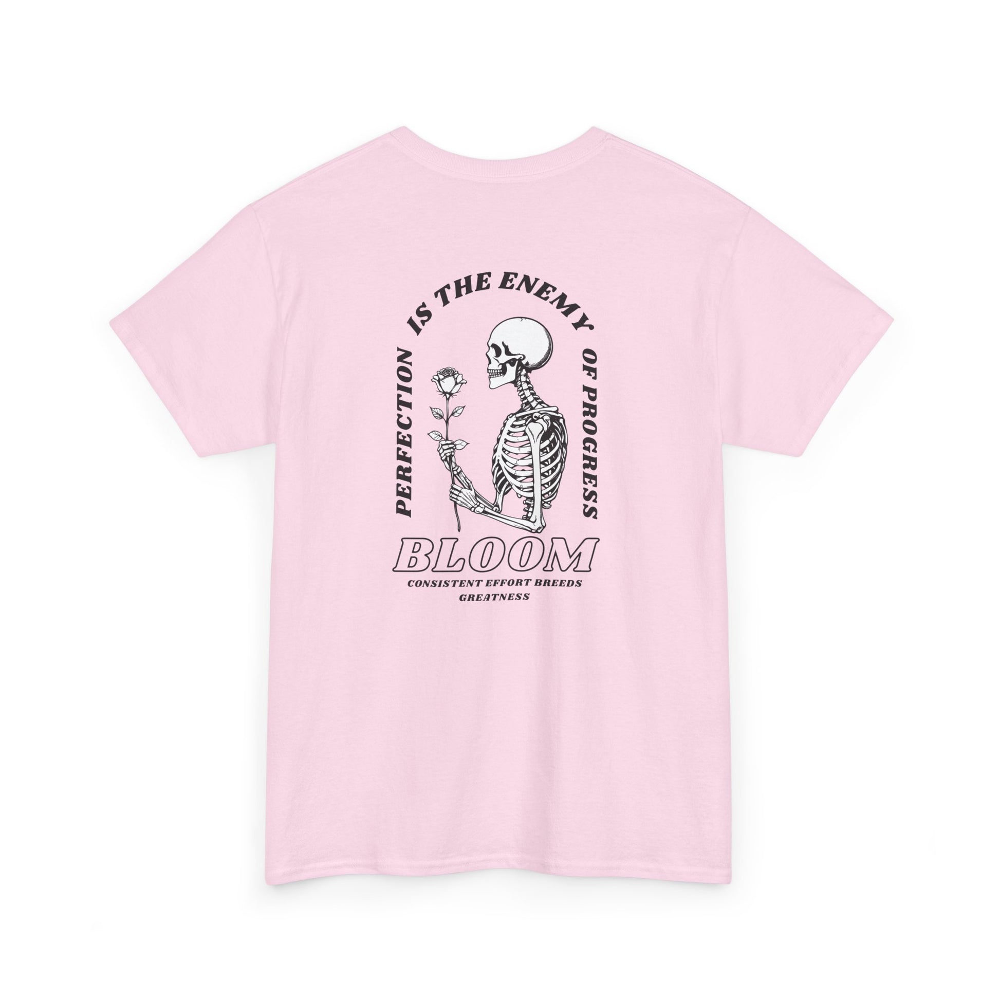 A [light pink] t-shirt with a central skeleton and rose design and the words “Perfection is the enemy of progress” and “Bloom” on the front.