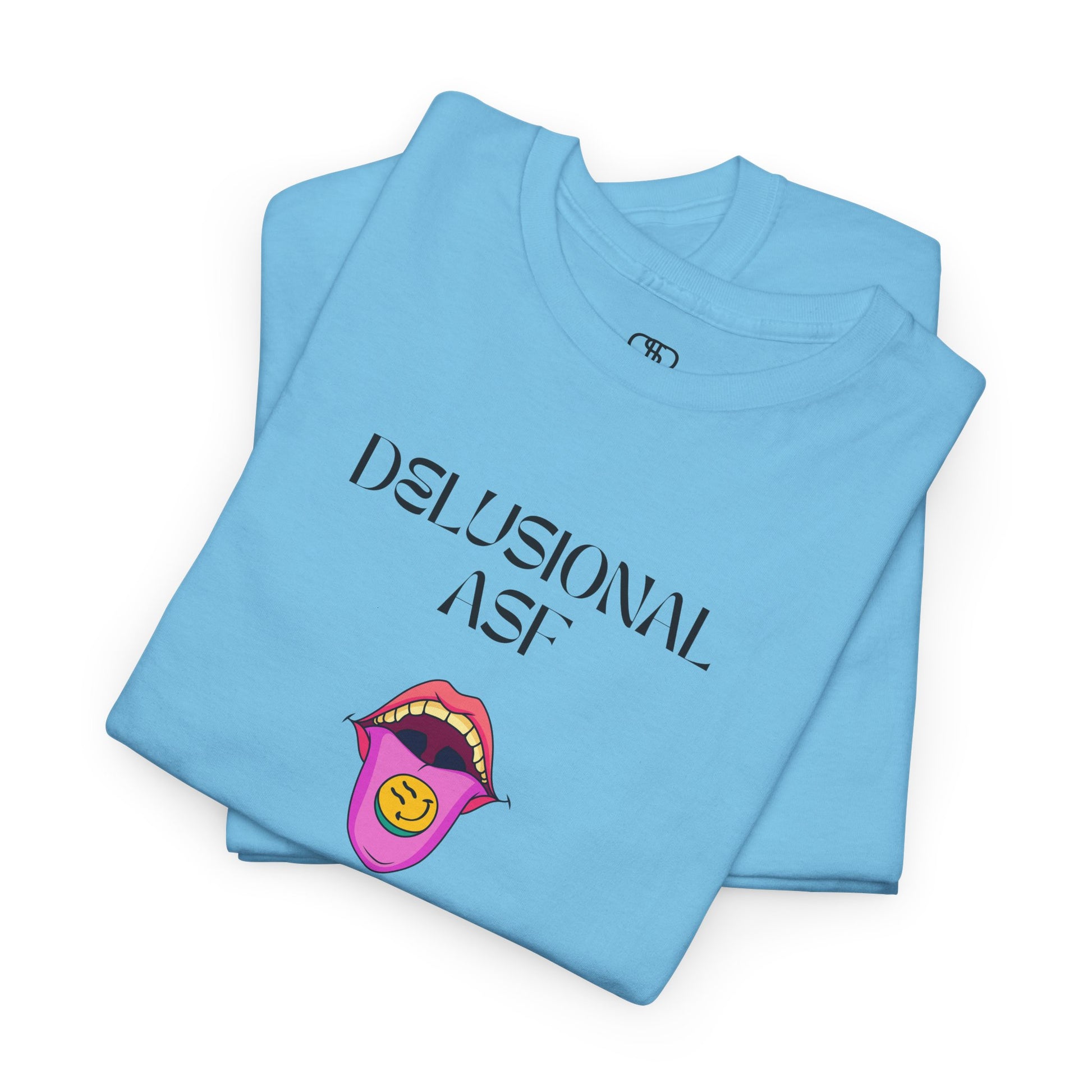 A folded sky blue T-shirt with "Delusional asf" text, an open mouth graphic with tongue out, and a happy face emoji pill.