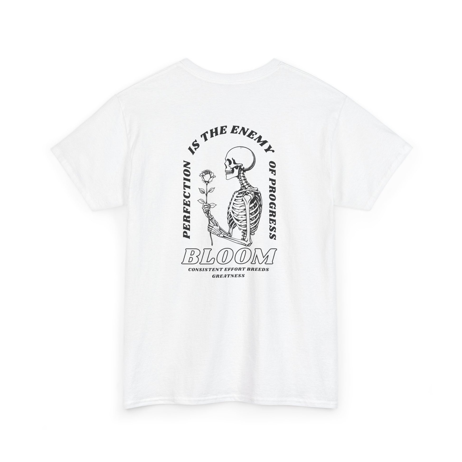 A [white] t-shirt with a central skeleton and rose design and the words “Perfection is the enemy of progress” and “Bloom” on the front.