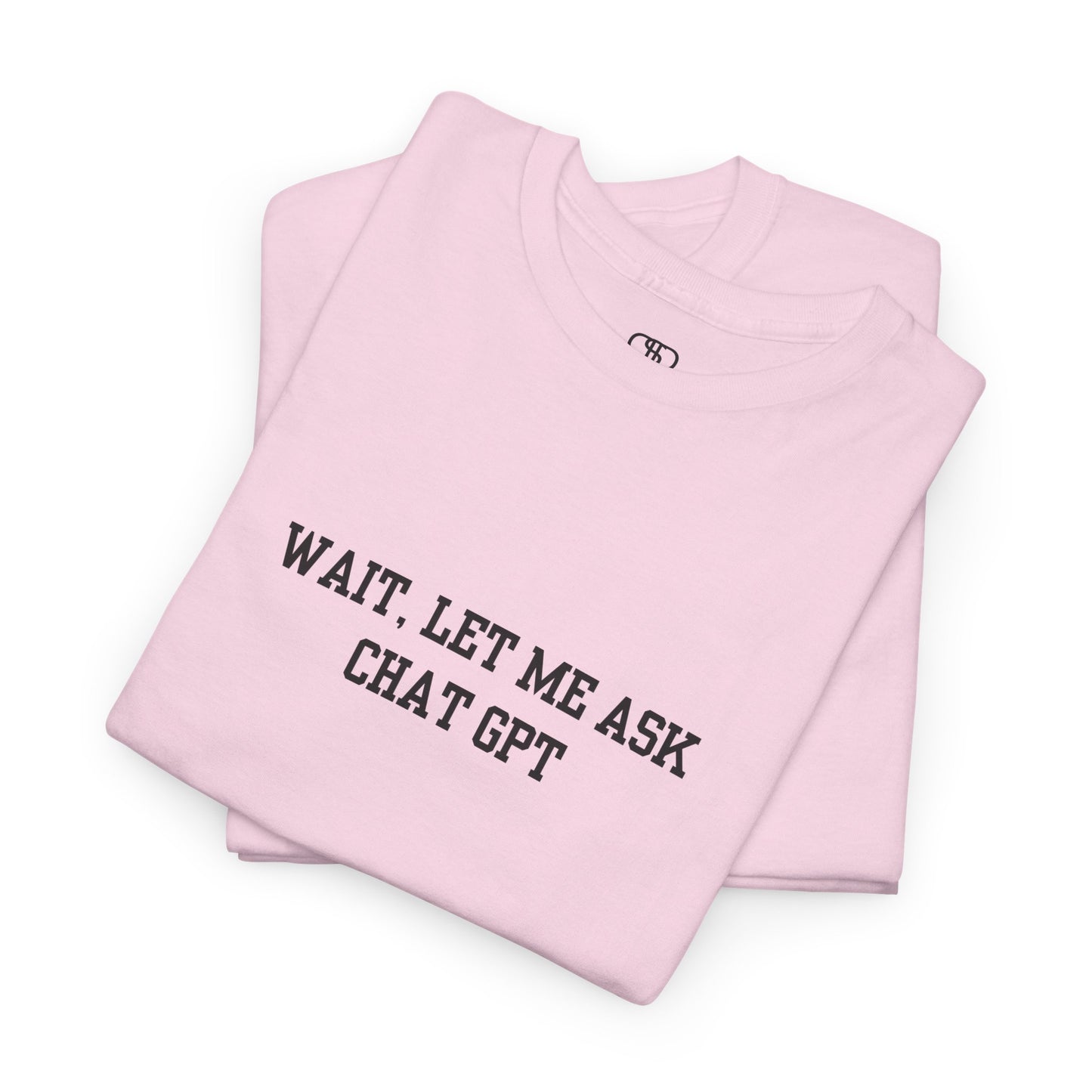 A [folded light pink] t-shirt with the phrase “Wait, Let me ask Chat Gpt.” on the front.