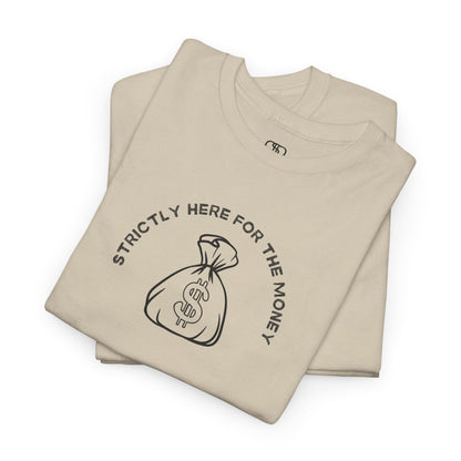 A folded sand T-shirt with curved text "Strictly here for the money" and a money bag graphic underneath.
