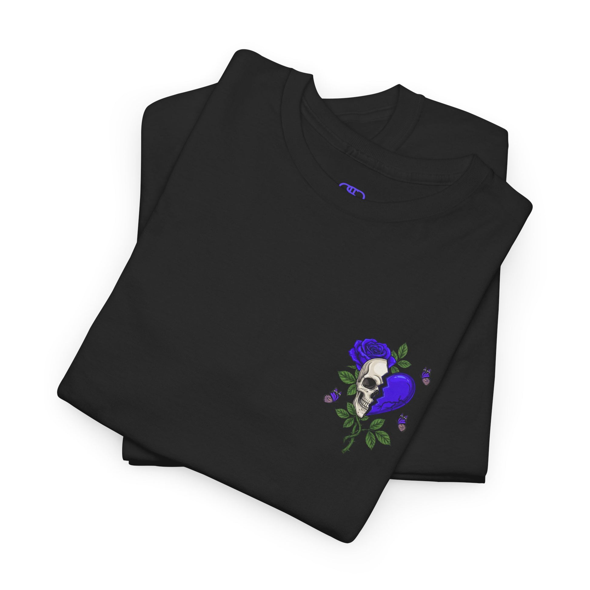 A folded black t-shirt with a front design of a half skull, half broken purple heart, and a rose. The back reads "Gym Heals" along with a similar design found on the front.
