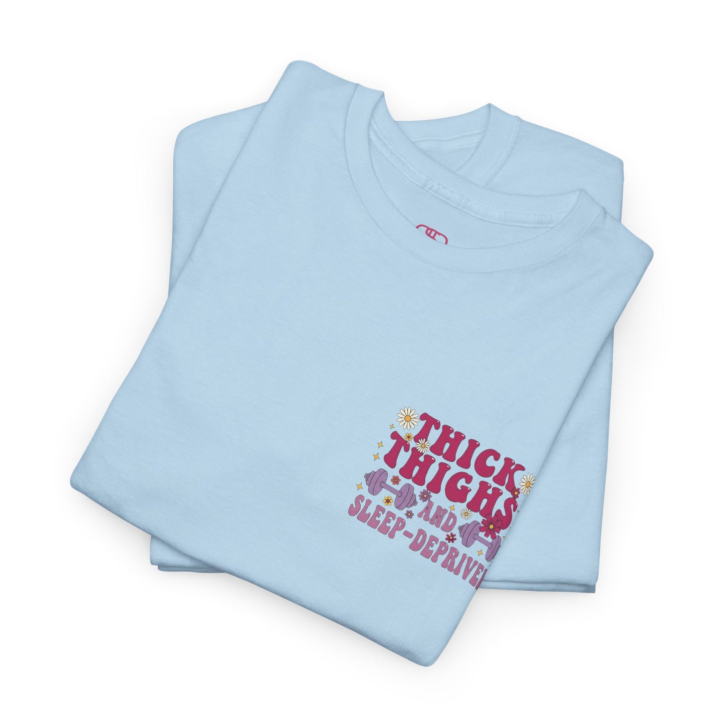 A [light blue] t-shirt with the phrase "Thick Thighs and Sleep Deprived" in a retro font on the front left and enlarged on the back.