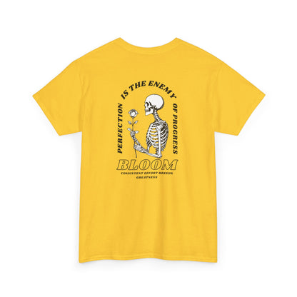 A [daisy] t-shirt with a central skeleton and rose design and the words “Perfection is the enemy of progress” and “Bloom” on the front.
