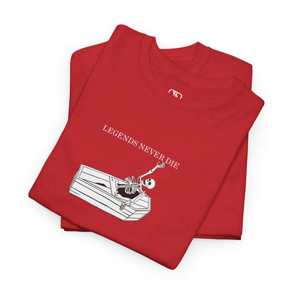 A folded red T-shirt with a skeleton breaking free from a casket, reaching up towards "Legends Never Die" text.