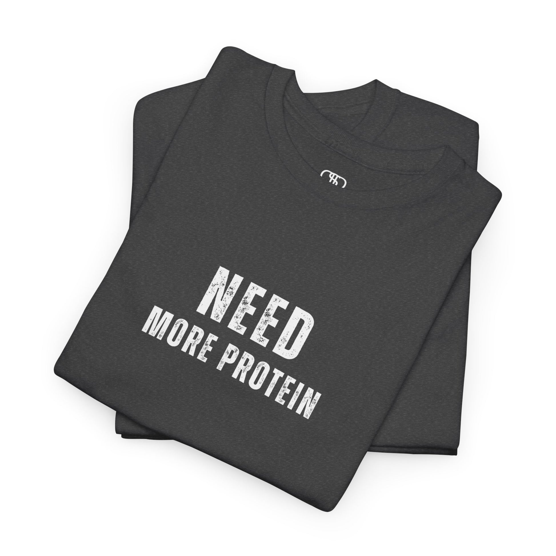 A folded heather gray t-shirt with the words “Need Protein” in a large grunge font.