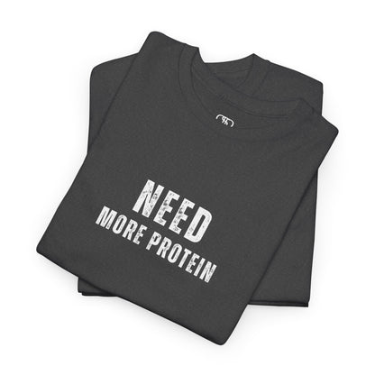 A folded heather gray t-shirt with the words “Need Protein” in a large grunge font.