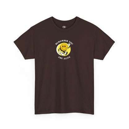 Front of a t-shirt showing a smiling waving emoji with curved text "Remember You Are Alive." The back shows a vibrant, smiling sunflower with the words "Make the Best Out of Everyday."