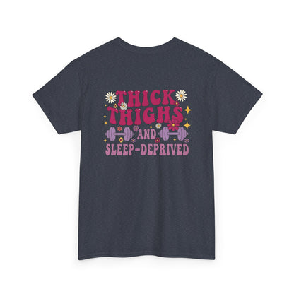 A [heather gray] t-shirt with the phrase "Thick Thighs and Sleep Deprived" in a retro font on the front left and enlarged on the back.