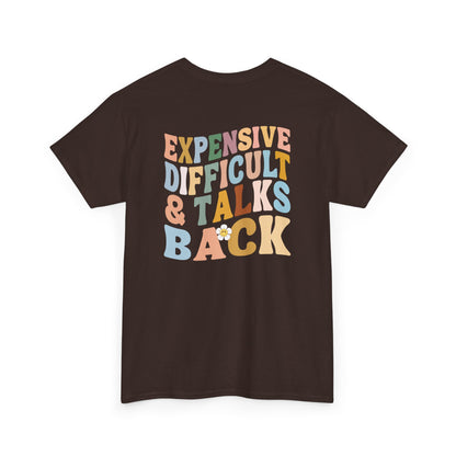 A dark brown t-shirt with a melting emoji and the words “Expensive Difficult & Talks Back” on the front and the full phrase in a retro wavy font on the back.