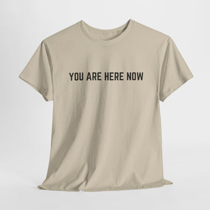 Front of a t-shirt with the grounding phrase "You are Here now" in a clean, minimalist font.