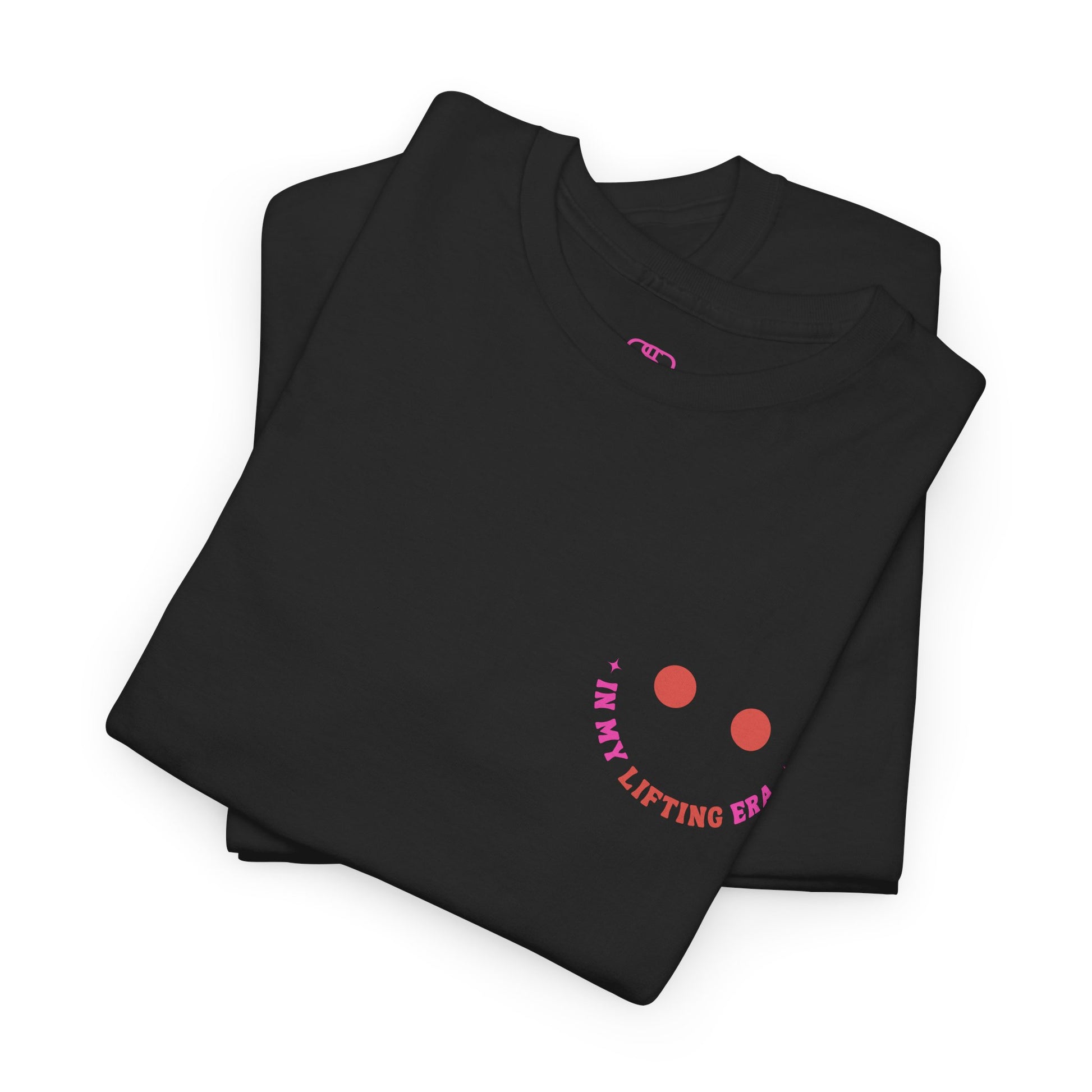 A folded black t-shirt with a retro smiley face on the front and the phrase “In my lifting Era” in a creative retro design on the back.