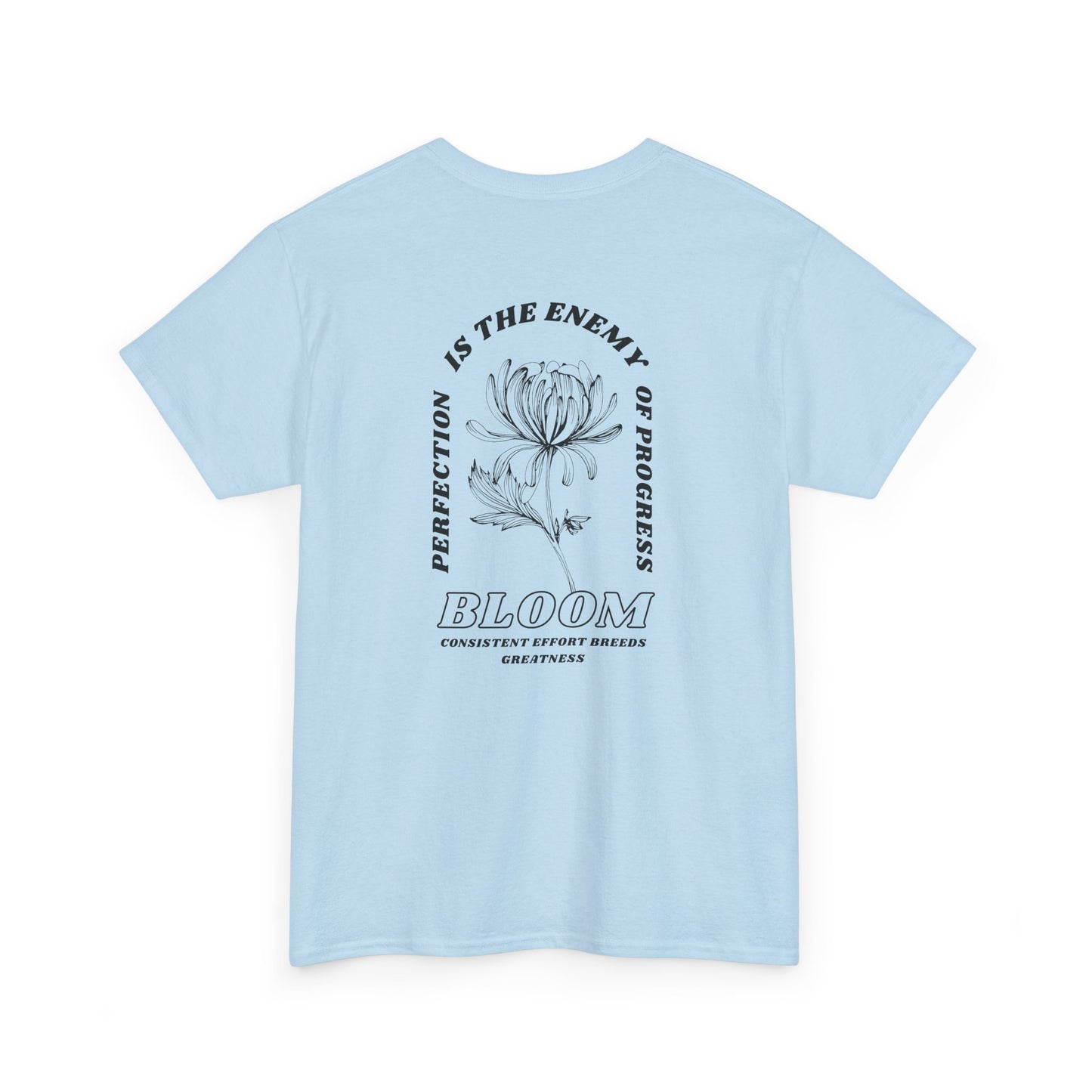 A [light blue] t-shirt with a central flower design and the words “Perfection is the enemy of progress” and “Bloom” underneath it the phrase "Consistent effort breeds greatness," featured on the back of the t-shirt.