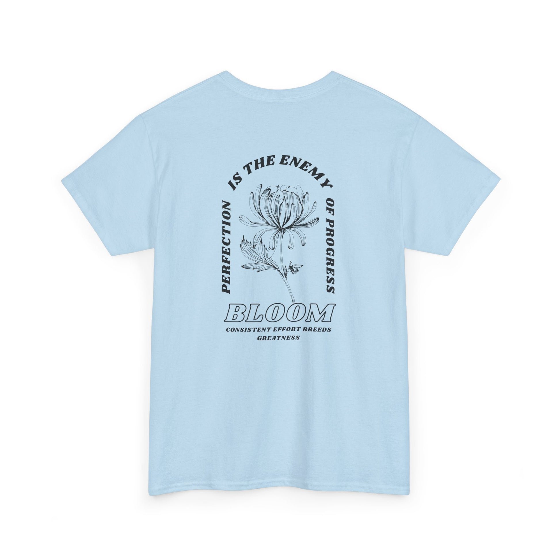 A [light blue] t-shirt with a central flower design and the words “Perfection is the enemy of progress” and “Bloom” underneath it the phrase "Consistent effort breeds greatness," featured on the back of the t-shirt.