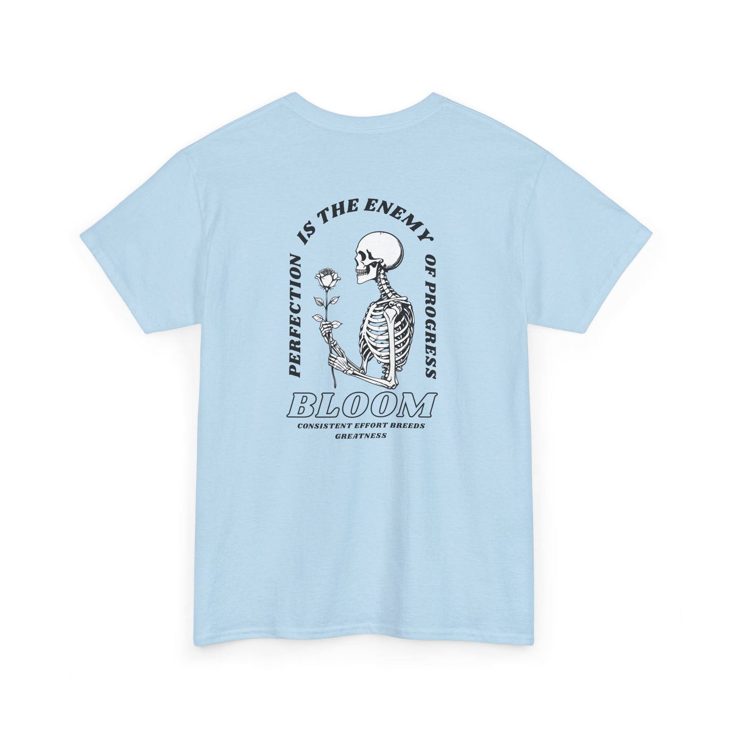 A [light blue] t-shirt with a central skeleton and rose design and the words “Perfection is the enemy of progress” and “Bloom” on the front.