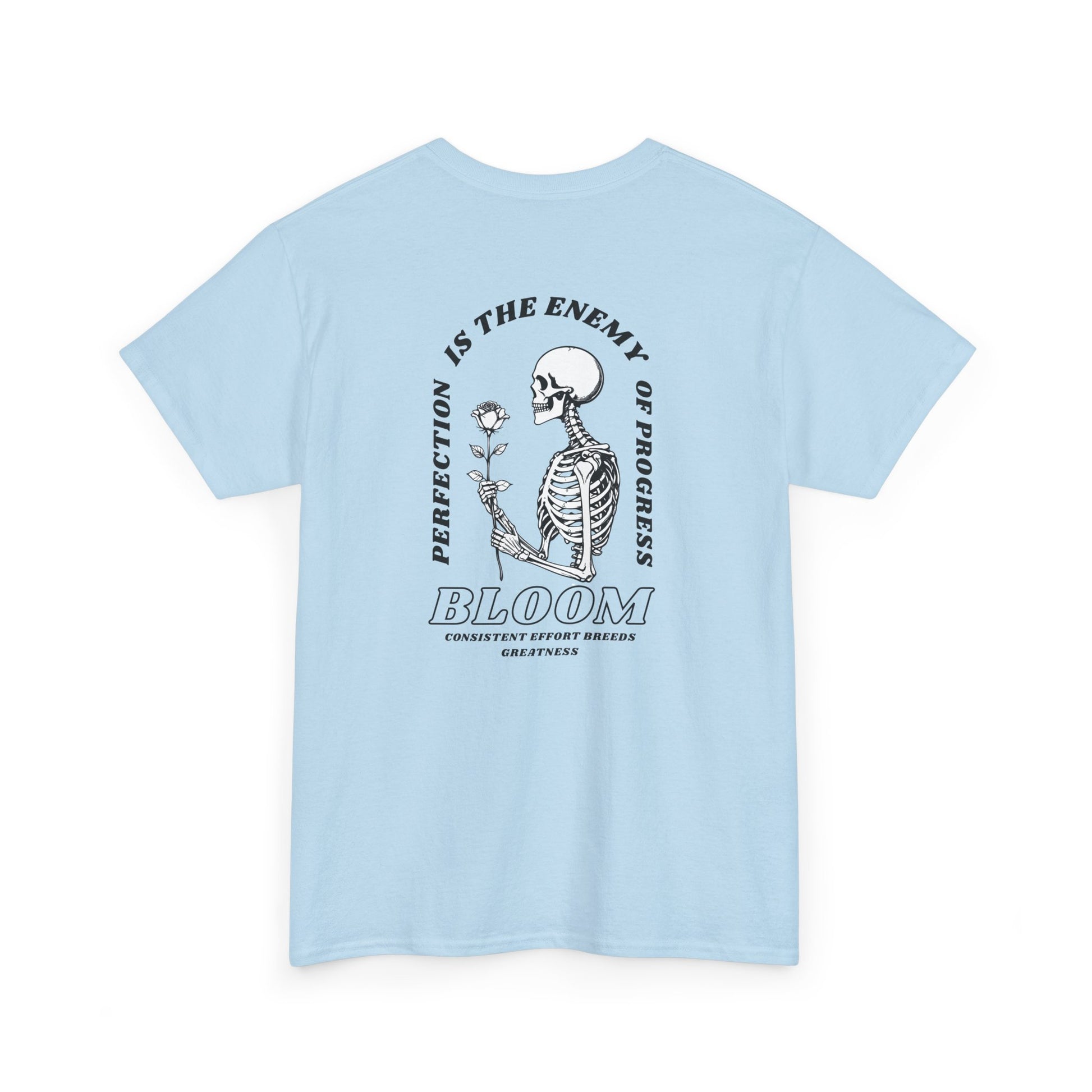 A [light blue] t-shirt with a central skeleton and rose design and the words “Perfection is the enemy of progress” and “Bloom” on the front.